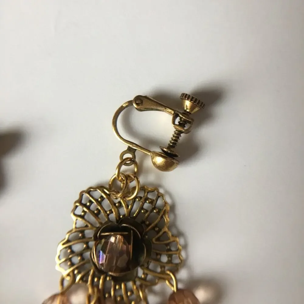 Darling ornate clip on earrings with beaded accents in amber/garnet tones